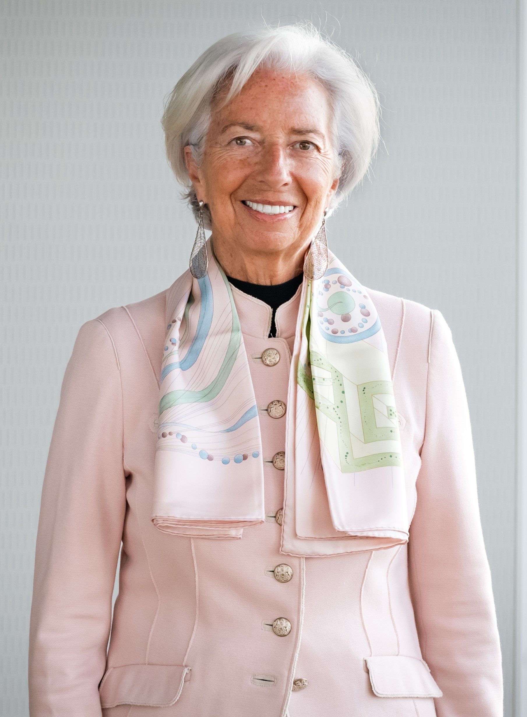 A person wearing a pink jacket and scarf

Description automatically generated